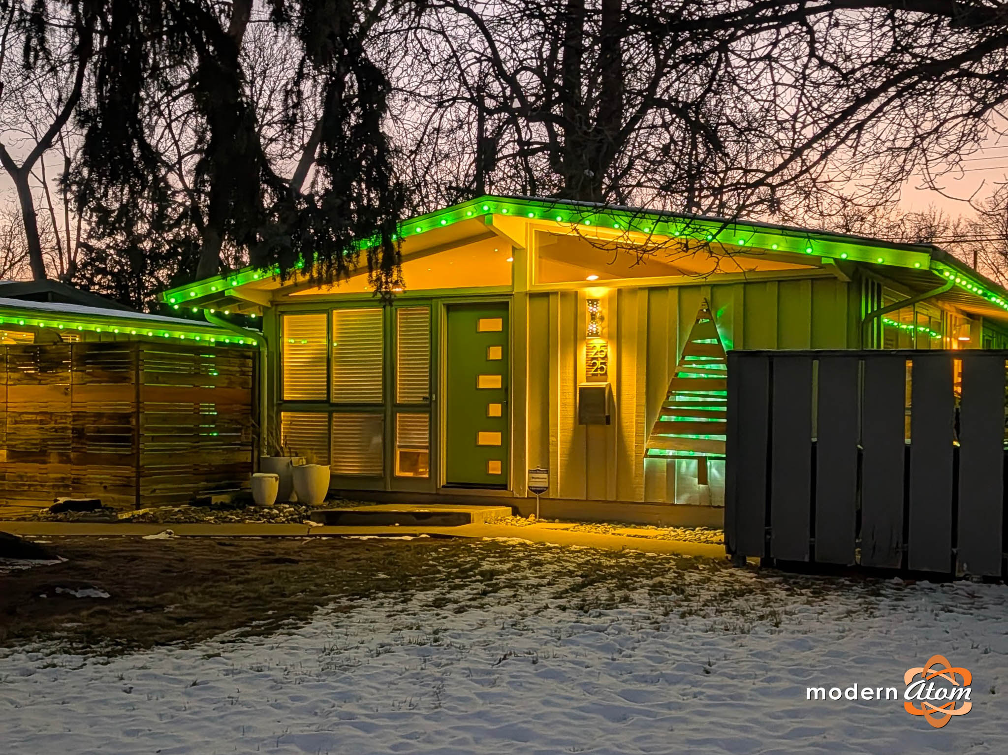 A Cliff May Home in Denver’s Harvey Park features green holiday lights, still shining bright in mid-January.